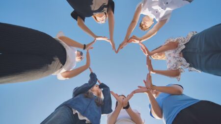 children make a heart shape from their hands